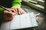 A person scheduling an appointment in their diary.